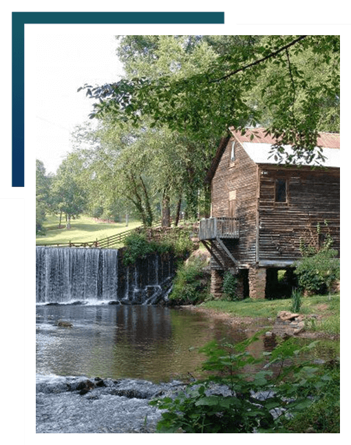 Scenic picture of a barn and waterfall landmark in Cleveland, GA