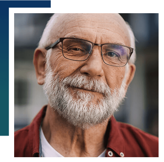 Elderly man wearing prism glasses